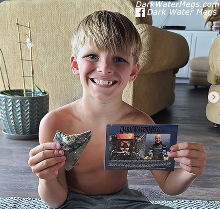 Kid with a dark water megs megalodon tooth