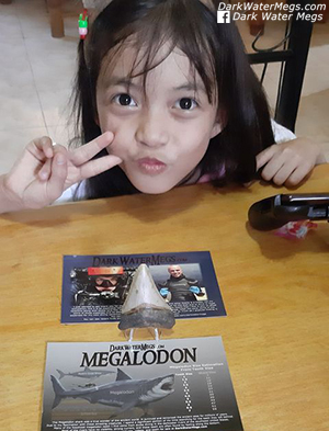 Kid with a dark water megs megalodon tooth
